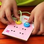 8564 *Montessori Early Education Wear Buttons* (12.5×14.5×1.5 cm.) 12 Pcs. 1 Camiseta d/Madera +10 Botones+1 Cordón.
